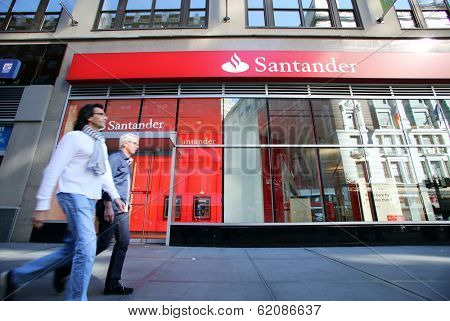 NEW YORK CITY - OCT 20 2013: Pedestrians walk past a branch of Santander Bank in Manhattan on Sunday, October 20, 2013. 