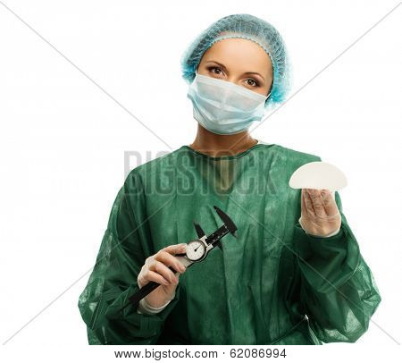 Plastic surgeon woman with silicon breast implants and calliper 
