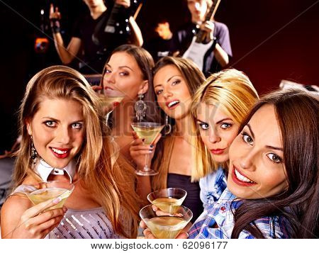 Group people on disco in night club. Lighting effects.