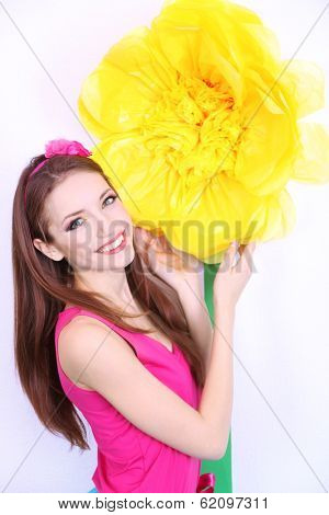 Beautiful young woman in petty skirt with big flower close up