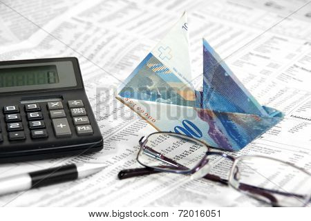 Swiss Banknote is folded as boat