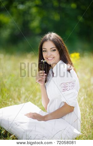 Girl resting on the soft pillow in fresh spring grass.