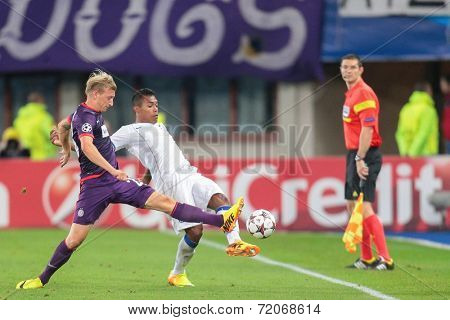 VIENNA, AUSTRIA - SEPTEMBER 18 Daniel Royer (#28 Austria) and JosuÃ?Ã?Ã?ÃÂ© (#8 Porto) fight for the ball at a UEFA Champions League game on September 18, 2013 in Vienna, Austria.