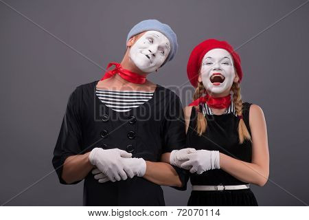 Portrait of funny mime couple with white faces and emotions isol