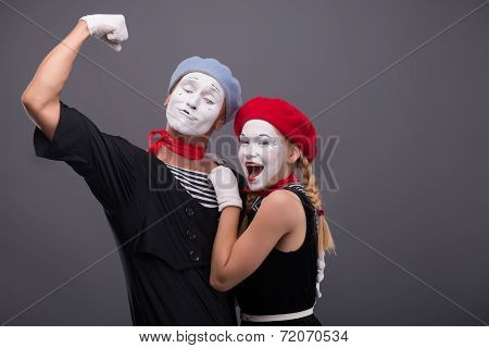 Portrait of funny mime couple with white faces and emotions isol