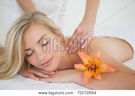 Pretty blonde enjoying a massage at the health spa