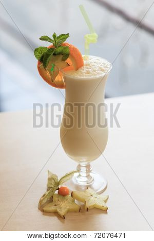 Milk cocktail with orange and carom