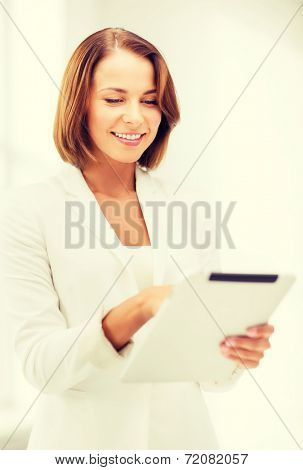 office, business, technology and internet concept - businesswoman with tablet pc in office