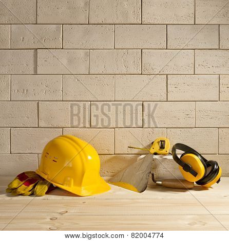 Brick Background, Helmet And Trowel