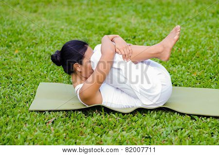Beautiful Woman Practicing Yoga In The Park