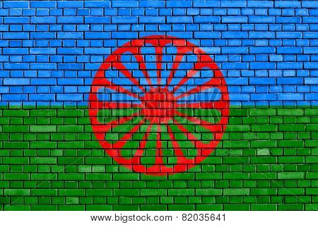 flag of Romani people painted on brick wall