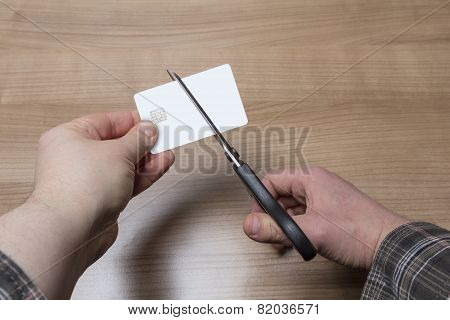 Hands Cutting A Credit Or Debit Card