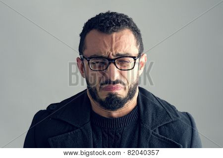 Man with sad expression isolated on grey backgrounf