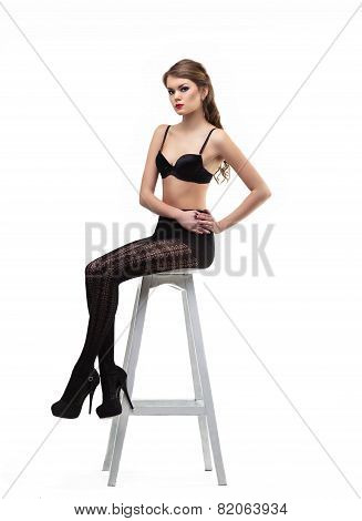 Sexy Girl In Black Pantyhose  And Bra Sit On Chair