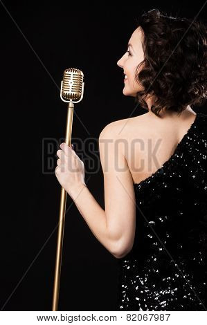 Beautiful Brunette Girl Vocalist Smiling Holding Golden Vintage Microphone