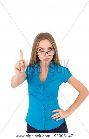 Beautiful Young Serious Businesswoman In Shirt Pointing Away While Standing Against White Background
