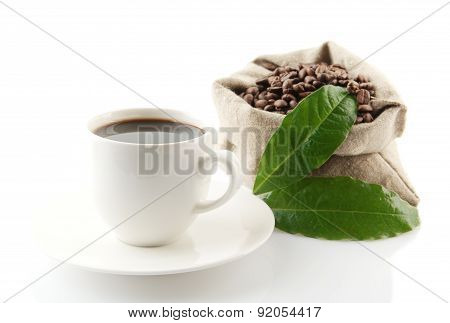 Sack Full Of Coffee Beans With Green Leaves And Coffee Cup