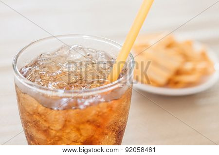 A Glass Of Cola With Snack On White Plate