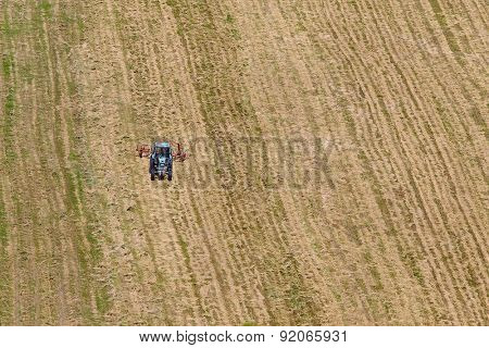 Tractor plowing the fild. Trademarks removed, original color scheme changed