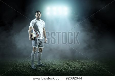 Soccer player with ball in action outdoors