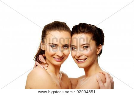 Two attractive sisters with make up embracing.