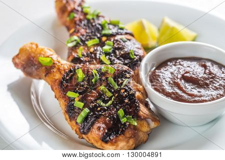 Grilled chicken drumsticks with tomato sauce on the plate