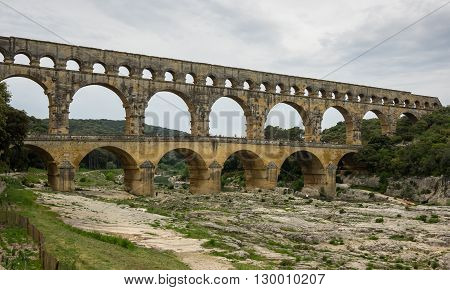 Pont du Gard in Provence France over the Gardon river is an 160 foot high roman aqueduct built to provide water to the city of Nimes from the river Eure near Uzes in the first century A.D.