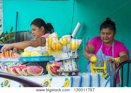 PANCHIMALCO EL SALVADOR - MAY 08 : A Salvadorian women sells fruits during the Flower & Palm Festival in Panchimalco El Salvador on May 08 2016