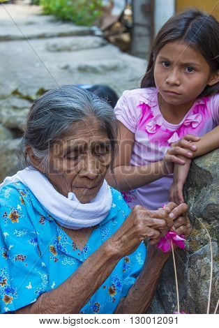 PANCHIMALCO EL SALVADOR - MAY 08 : A Salvadoran woman decorates palm fronds with flowers during the Flower & Palm Festival in Panchimalco El Salvador on May 08 2016