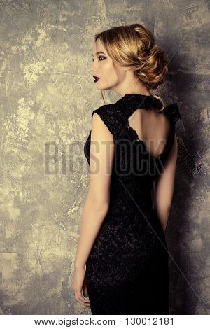 Vogue shot of a beautiful young woman with dark make-up. Cosmetics, maroon lipstick. Studio shot.