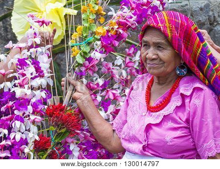 PANCHIMALCO EL SALVADOR - MAY 08 : A Salvadoran woman decorates palm fronds with flowers during the Flower & Palm Festival in Panchimalco El Salvador on May 08 2016