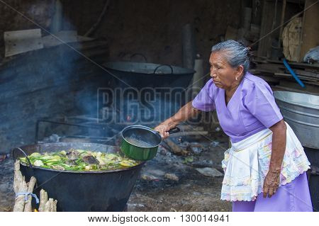 PANCHIMALCO EL SALVADOR - MAY 08 : A Salvadoran woman cooks during the Flower & Palm Festival in Panchimalco El Salvador on May 08 2016
