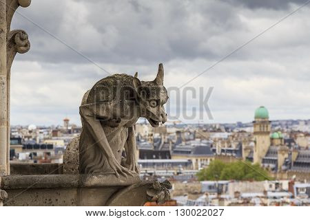 Paris, France - May 13: This is one of the statues of chimeras are installed on the top floor at the foot of the towers of Notre-Dame de Paris May 13, 2013 Paris, France.