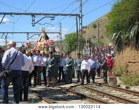Alora Spain 24 April 2016: Religious procession crossing railway line near Alora Andalucia. Alora Spain 24 April 2016