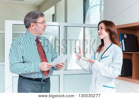 The patient and his doctor in medical office. Healthcare concept