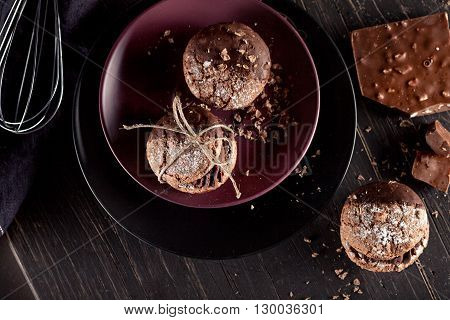 Italian maroni cookies on the plate and chocolate milkshakes cloth notebook on dark old wooden background top view
