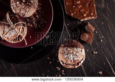 Italian maroni cookies with pieces of chocolate on old wooden background