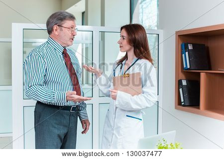 The patient and his doctor in medical office. Healthcare concept