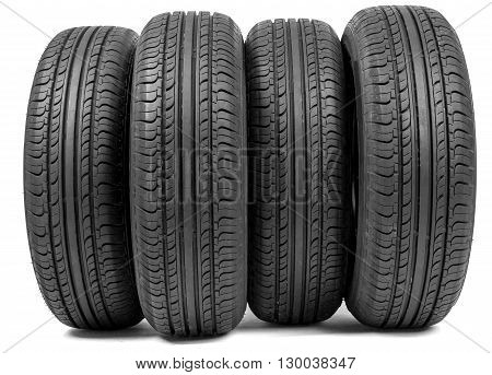 Complete set of new tyres for car on white background