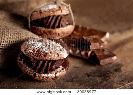 Italian maroni cookies with pieces of chocolate on old wooden background