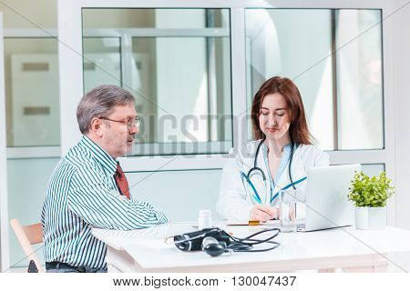 The patient and his doctor in medical office. Healthcare concept