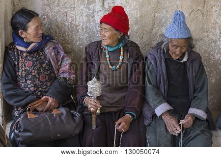 LAMAYURU INDIA - JUNE 15 2015: Unidentified buddhist old women during mystical mask dancing Tsam mystery dance in time of Yuru Kabgyat Buddhist festival at Lamayuru Gompa Ladakh North India