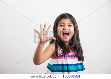 indian small girl counting five, asian small girl showing 5 fingers or five numbers with fingers
