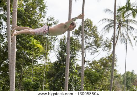 KOH PHANGAN. THAILAND - NOVEMBER 25 2014 : Unidentified man jump in the pool in the attraction Slip N Fly on island Koh Phangan