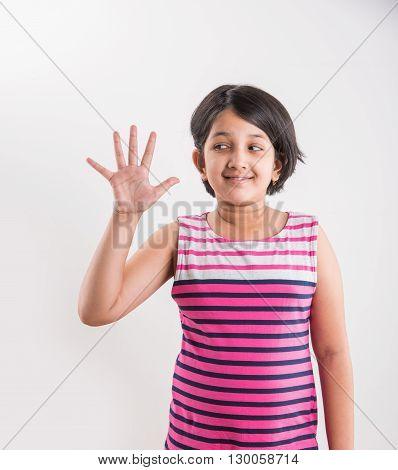 indian small girl counting five, asian small girl showing 5 fingers or five numbers with fingers