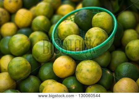 Yellow Lemons and Green lemons in the basket