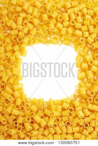 Square frame made of dry ditalini yellow pasta over isolated white background