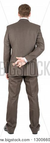 Businessman with his fingers crossed behind his back. Concept for good luck or dishonesty