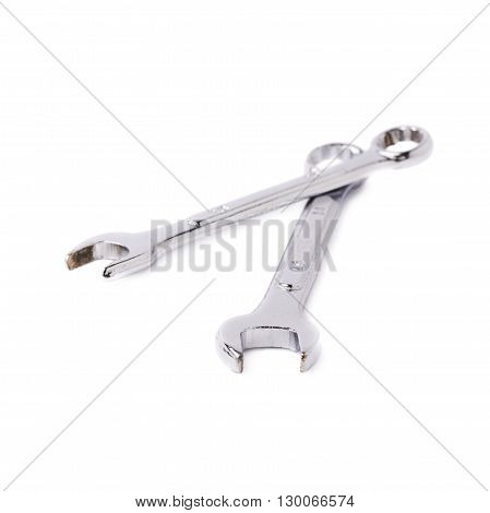 Couple of wrenchs chrome metal spanner instruments isolated over white background