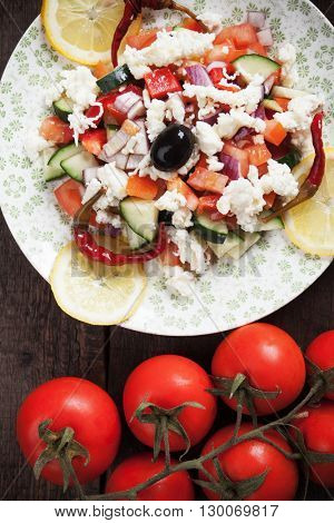 Shopska salad with cheese, olives, cucumber, tomato, onion and chili peppers